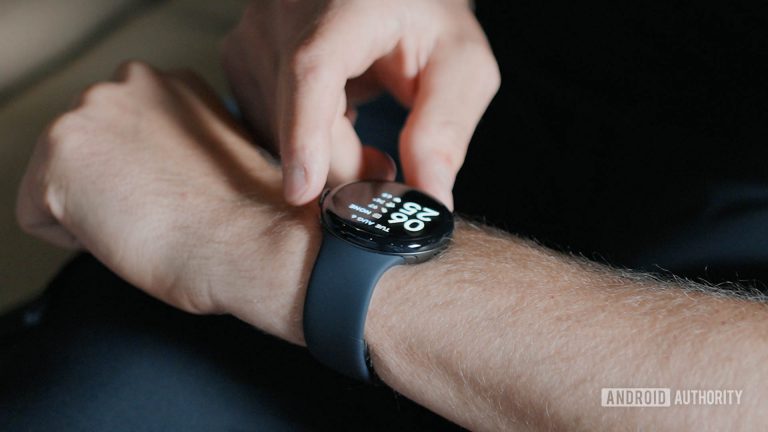 A-man-presses-the-crown-of-a-Google-Pixel-Watch-3-on-his-arm