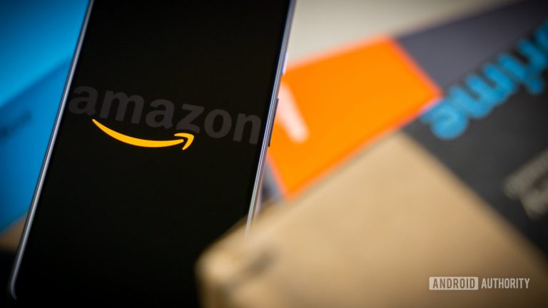 Amazon-logo-on-phone-next-to-boxes-stock-photo-12